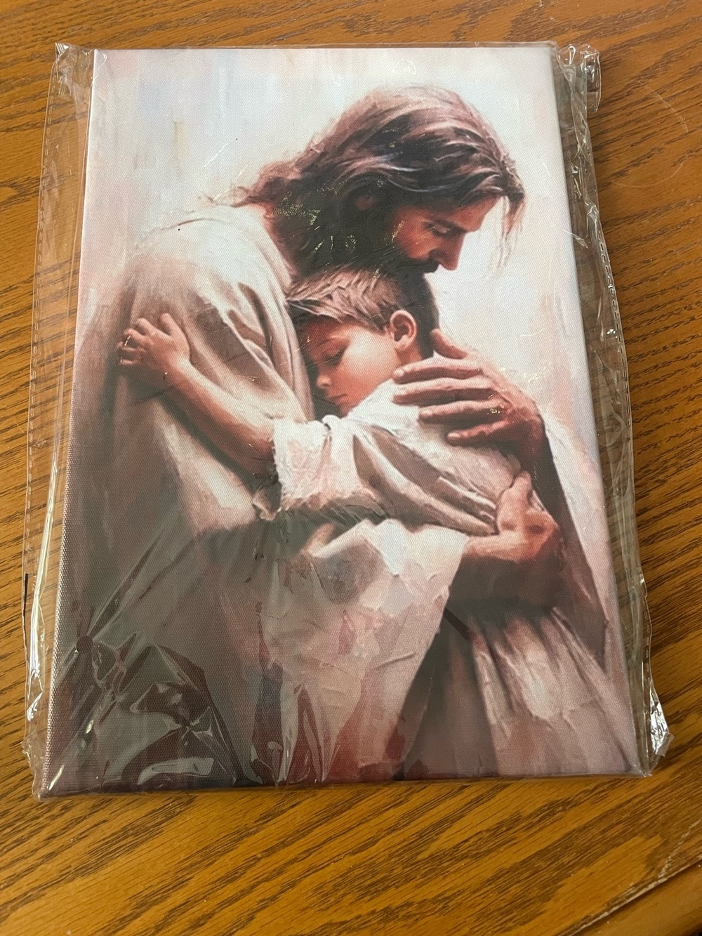 Canvas painting of Jesus embracing little boy